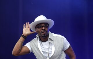 Teddy Riley Wearing a White Color Shirt and Cap